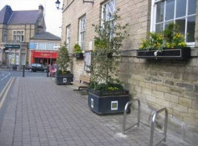 A flat and wide footway with good provision of seating and planters